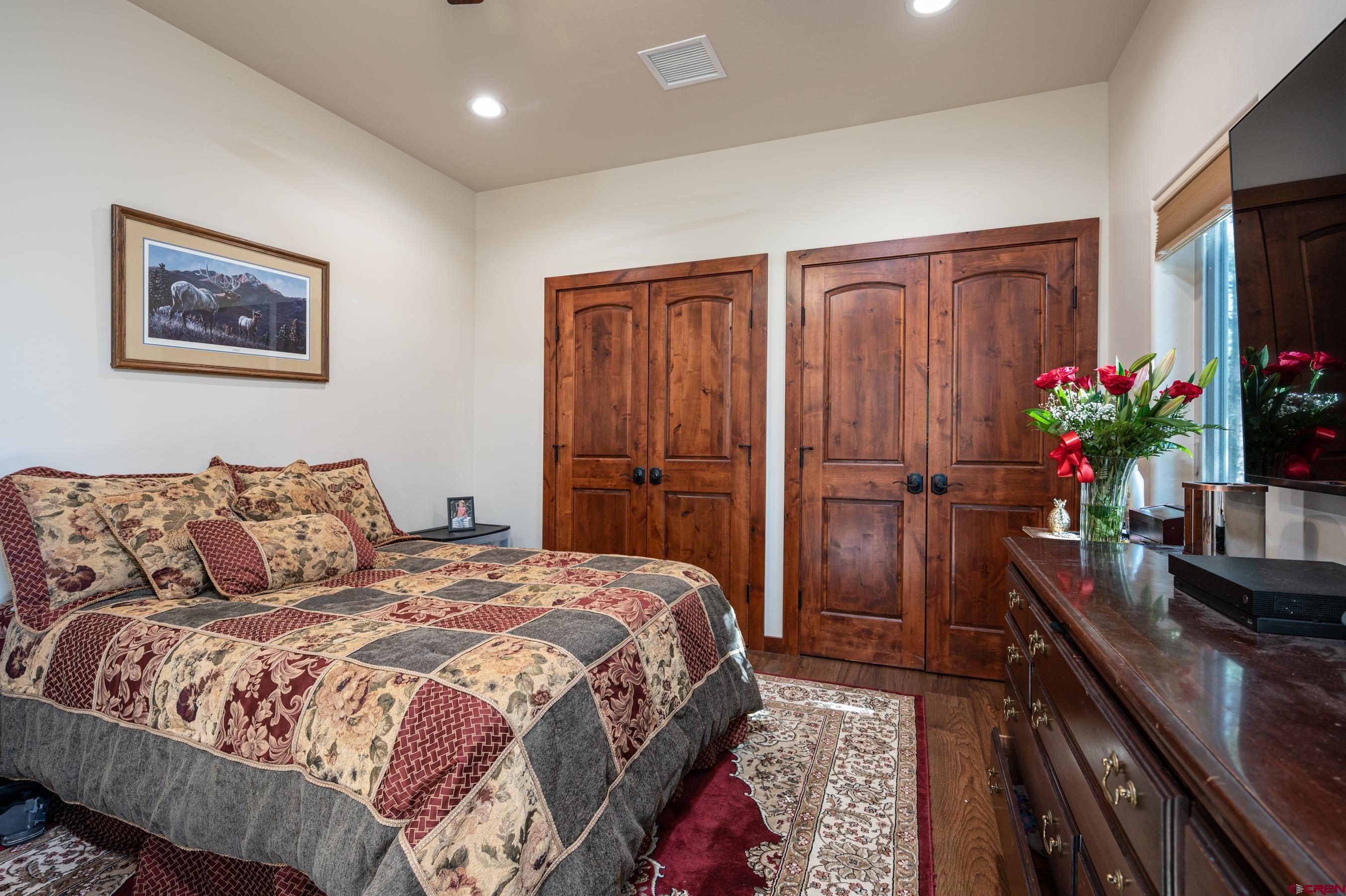 180 Ridge Road Durango, CO 81303 - Photo 22 of 35 a bedroom with bed and a flat screen tv