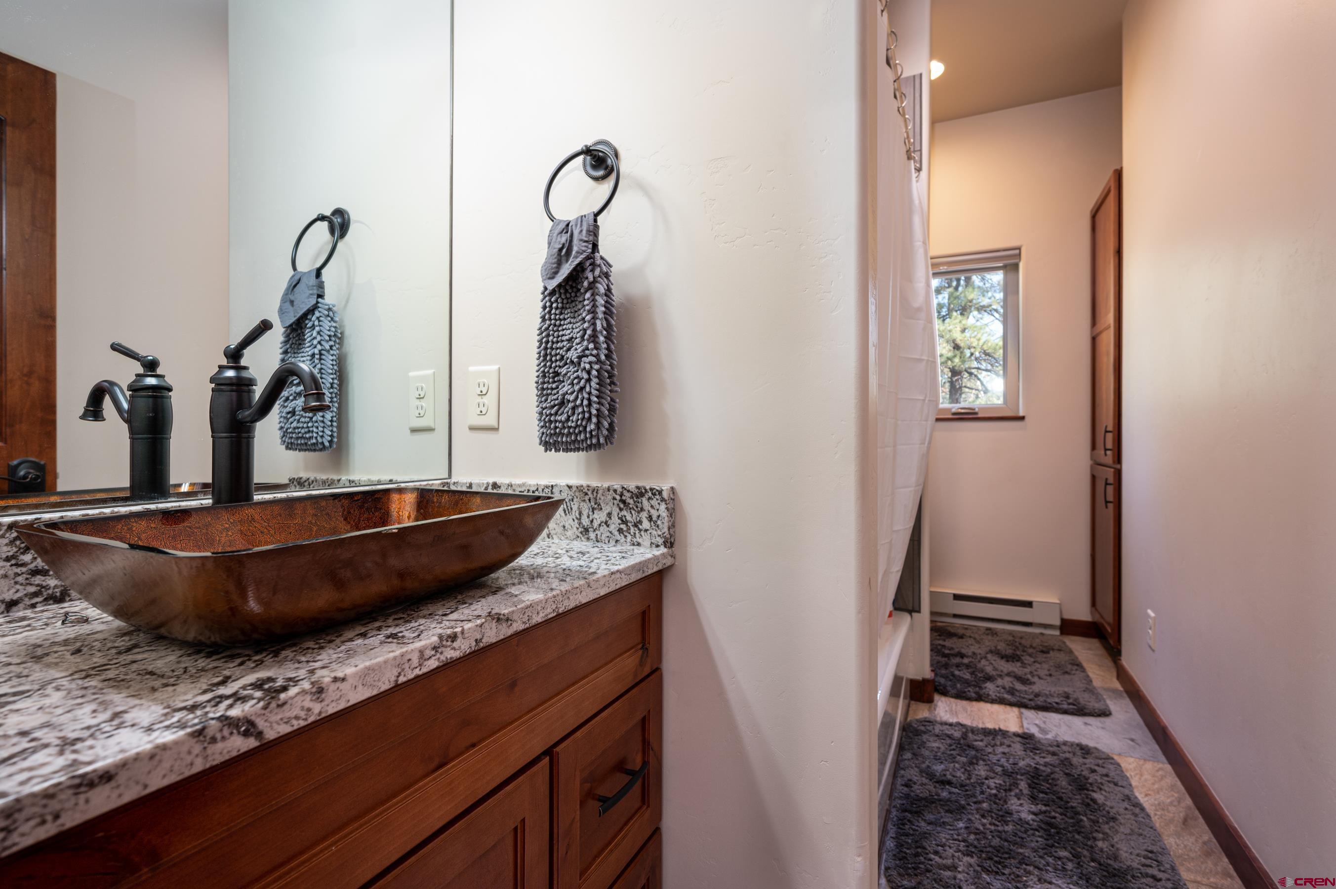 180 Ridge Road Durango, CO 81303 - Photo 23 of 35 a bedroom with a large bed and a potted plant