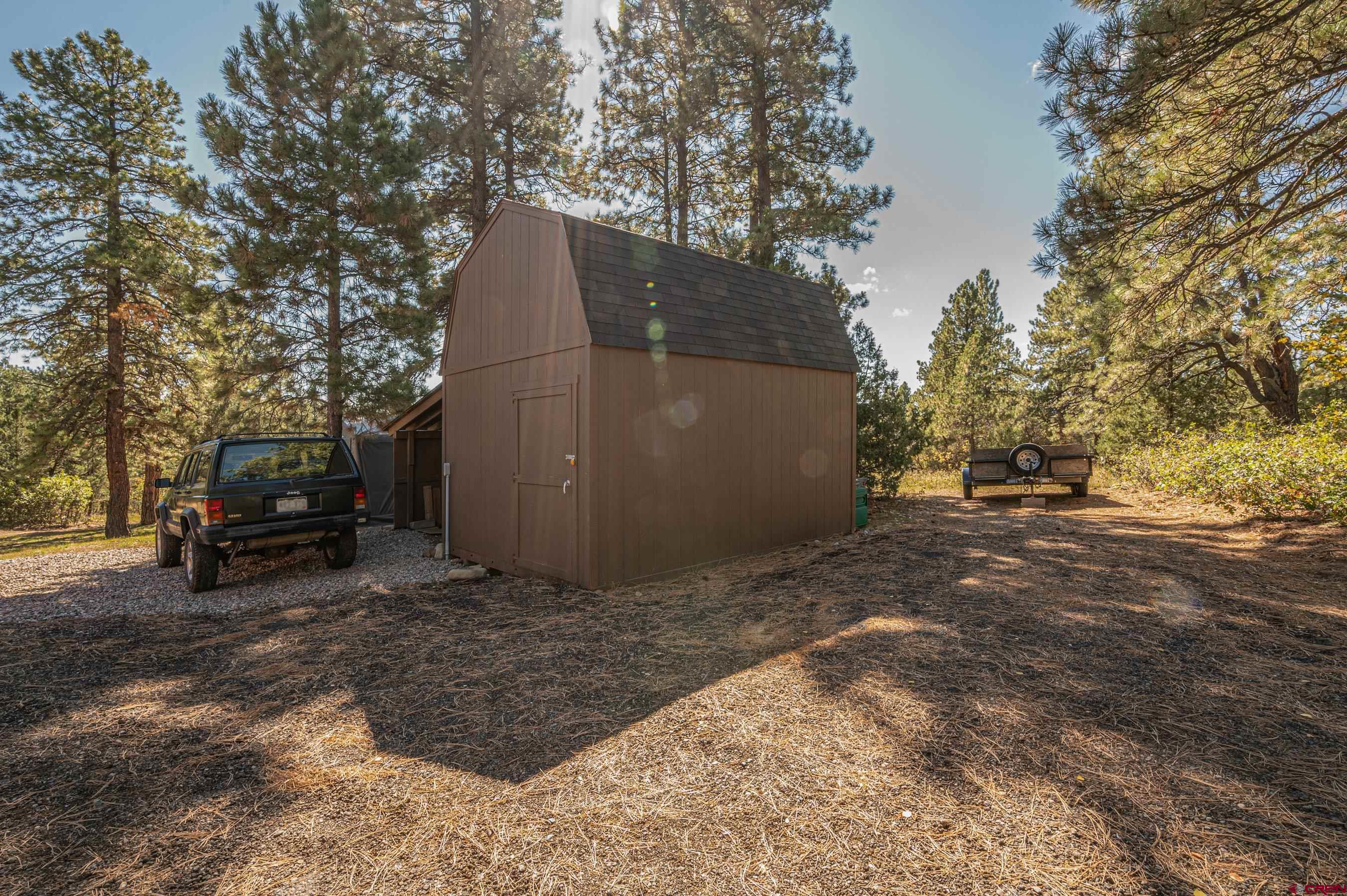 180 Ridge Road Durango, CO 81303 - Photo 32 of 35 a front view of a house with a yard covered with snow