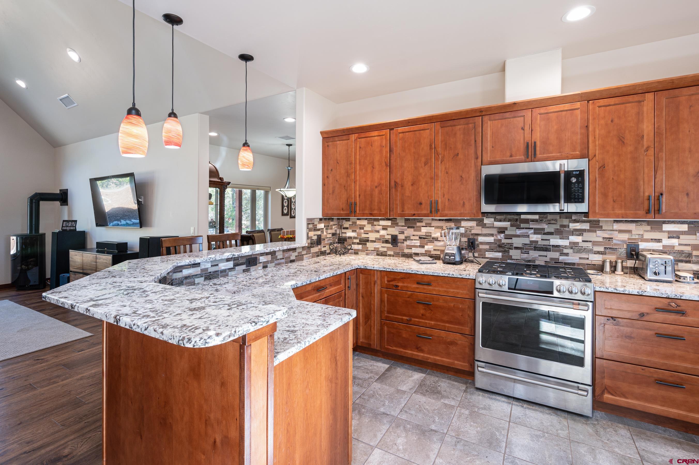 180 Ridge Road Durango, CO 81303 - Photo 9 of 35 a kitchen with stainless steel appliances granite countertop a sink a stove and a wooden cabinets