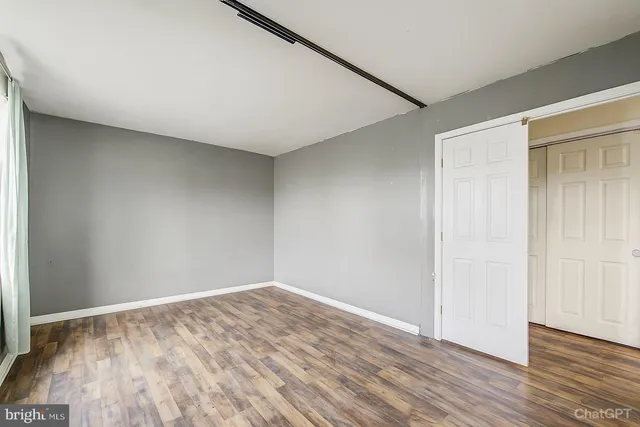 an empty room with wooden floor