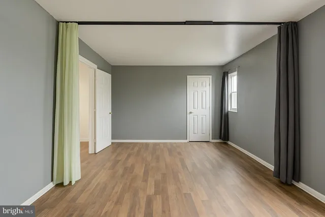 a view of a room with wooden floor