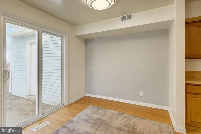 a view of a room with wooden floor and windows