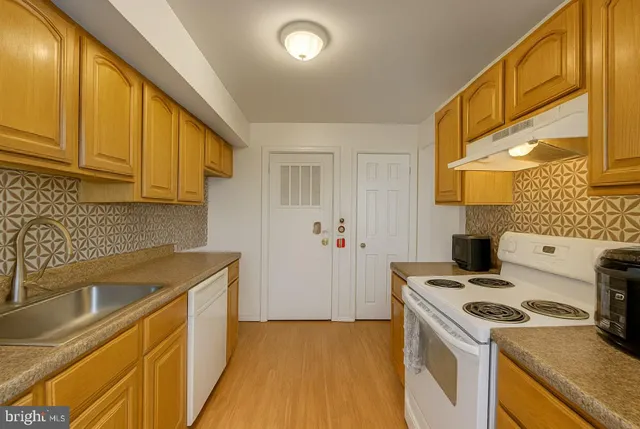a kitchen that has a sink and a stove