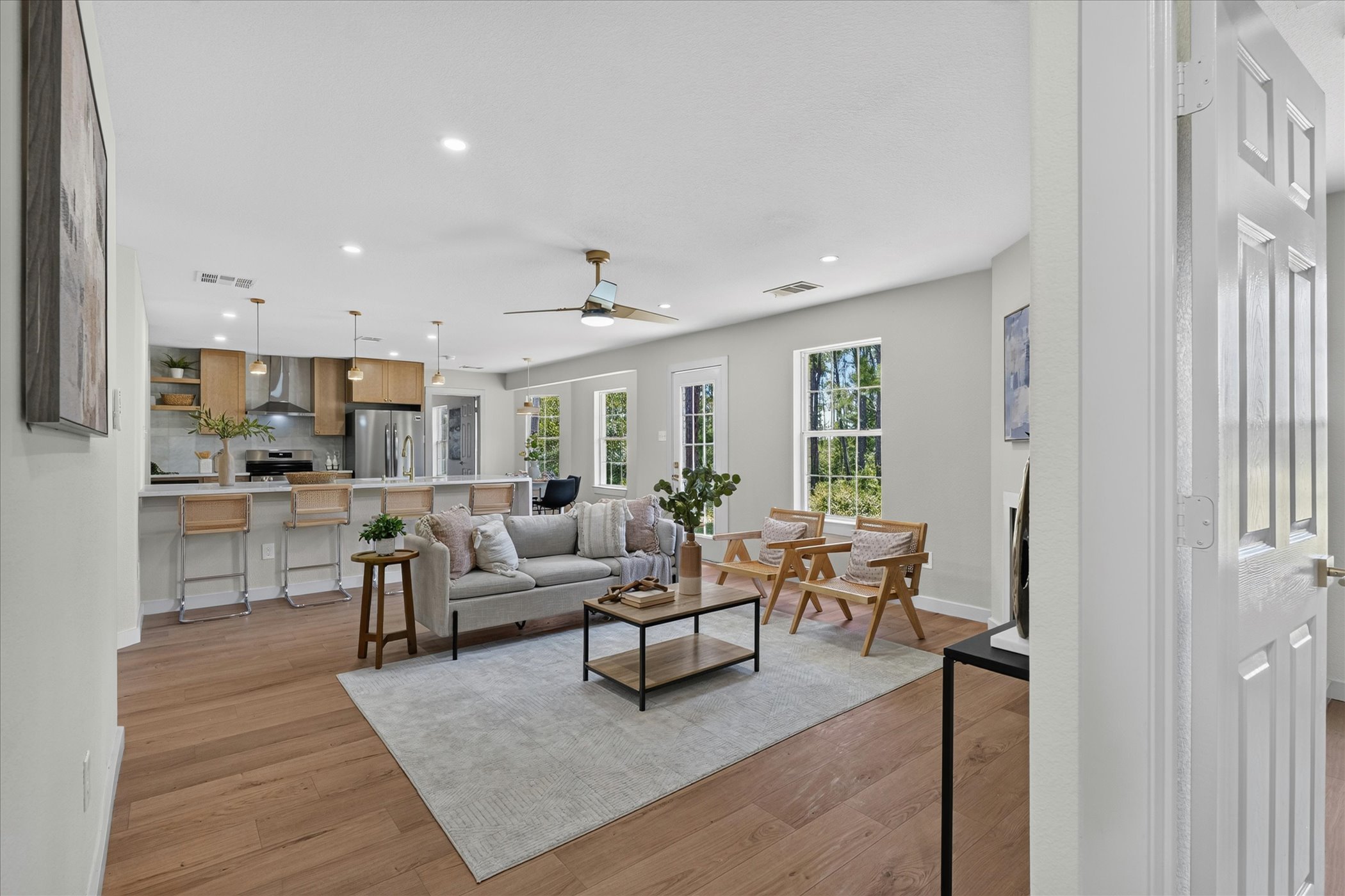 258 Pine View Loop Bastrop, TX 78602 - Photo 16 of 40 An open-concept living area flows seamlessly into a modern kitchen, creating an inviting space.