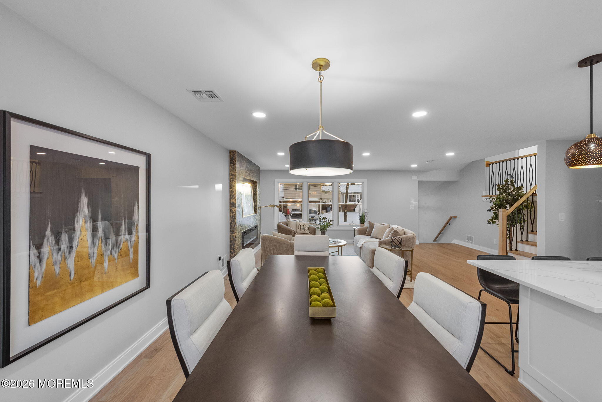 64 South Cliff Road Colonia, NJ 07067 - Photo 14 of 49 a view of a dining room and livingroom with furniture wooden floor a chandelier