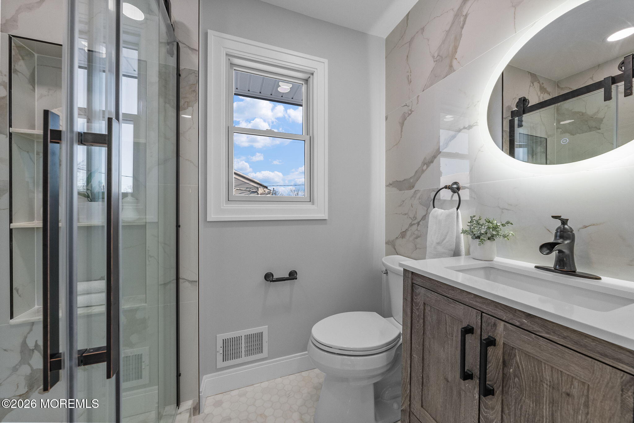 64 South Cliff Road Colonia, NJ 07067 - Photo 27 of 49 a bathroom with a toilet a sink and mirror