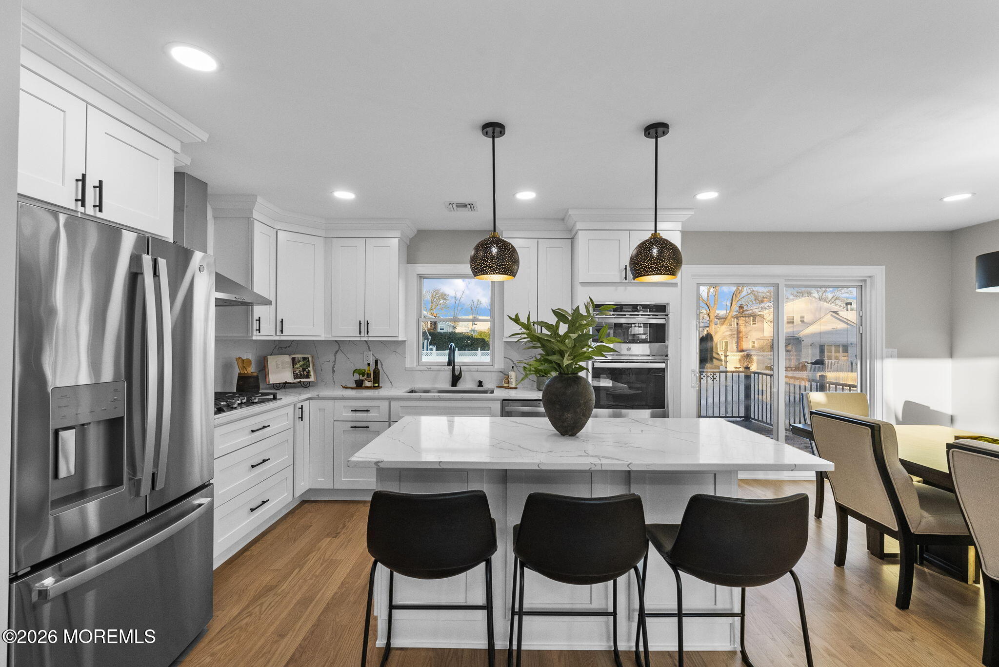 64 South Cliff Road Colonia, NJ 07067 - Photo 6 of 49 a kitchen with granite countertop white cabinets and stainless steel appliances