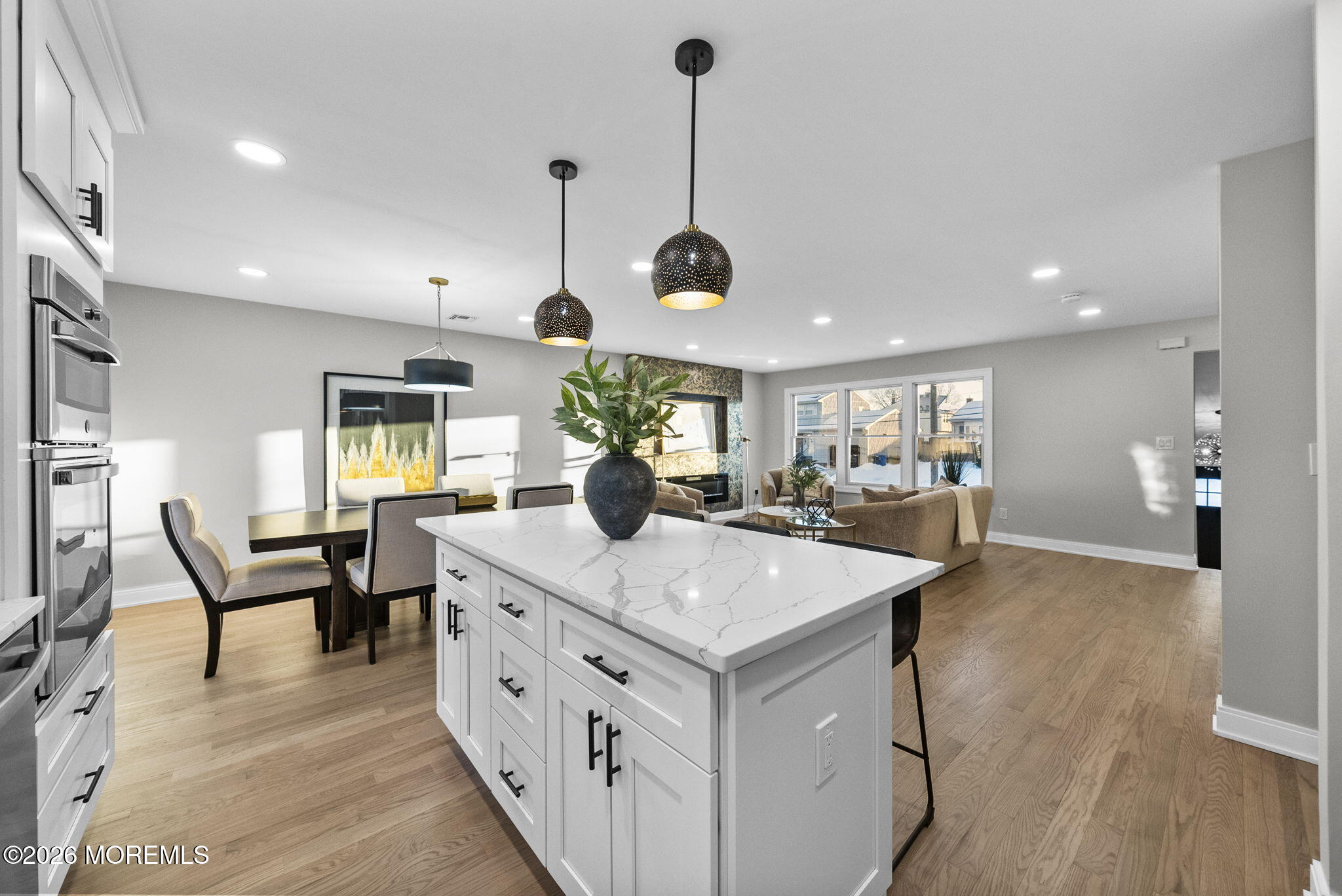 64 South Cliff Road Colonia, NJ 07067 - Photo 10 of 49 a large white kitchen with a dining table chairs and couches