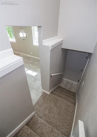 408 Placid Road Colorado Springs, CO 80910 - Photo 20 of 36 The stairs lead you to the upper and lower levels.