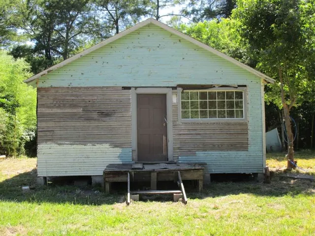 a view of house with backyard