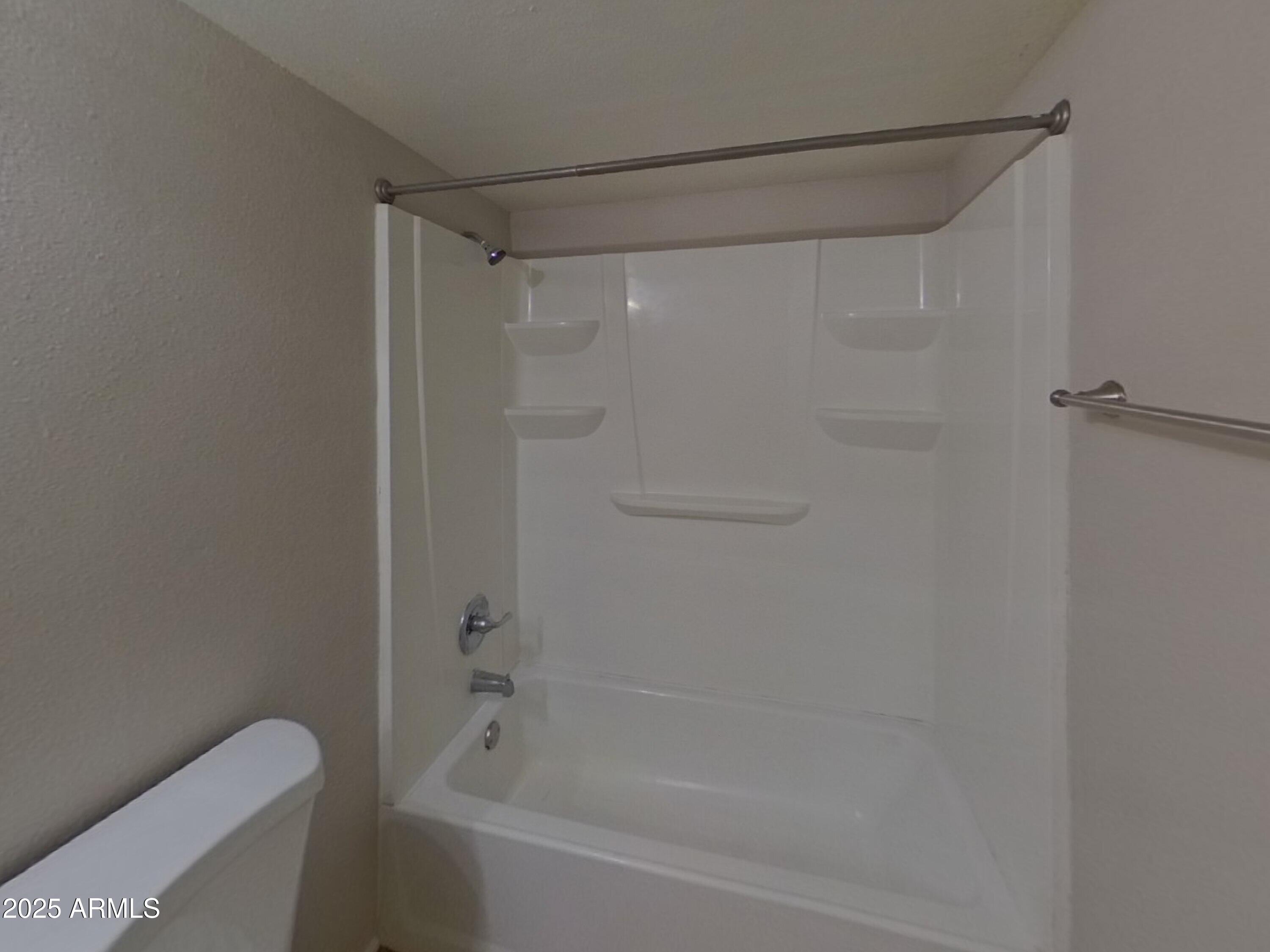 7955 West Montecito Avenue Phoenix, AZ 85033 - Photo 14 of 19 a bathroom with a shower and a toilet