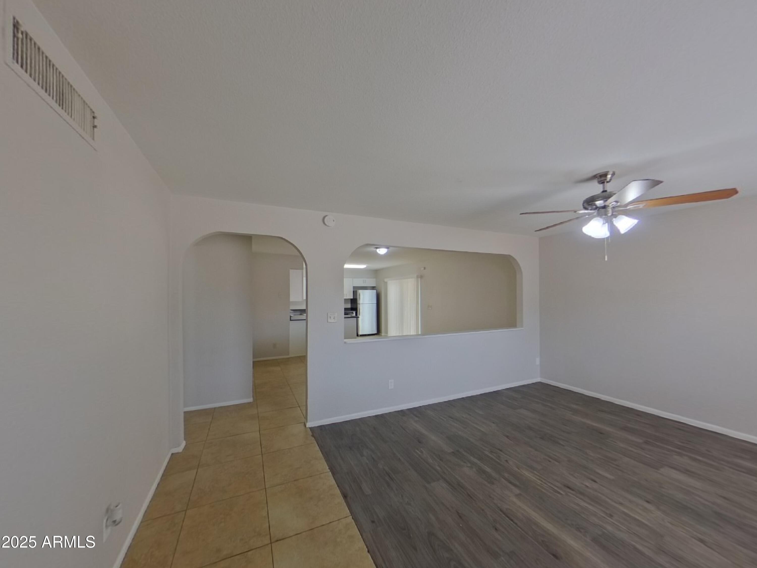 7955 West Montecito Avenue Phoenix, AZ 85033 - Photo 4 of 19 a view of empty room with wooden floor