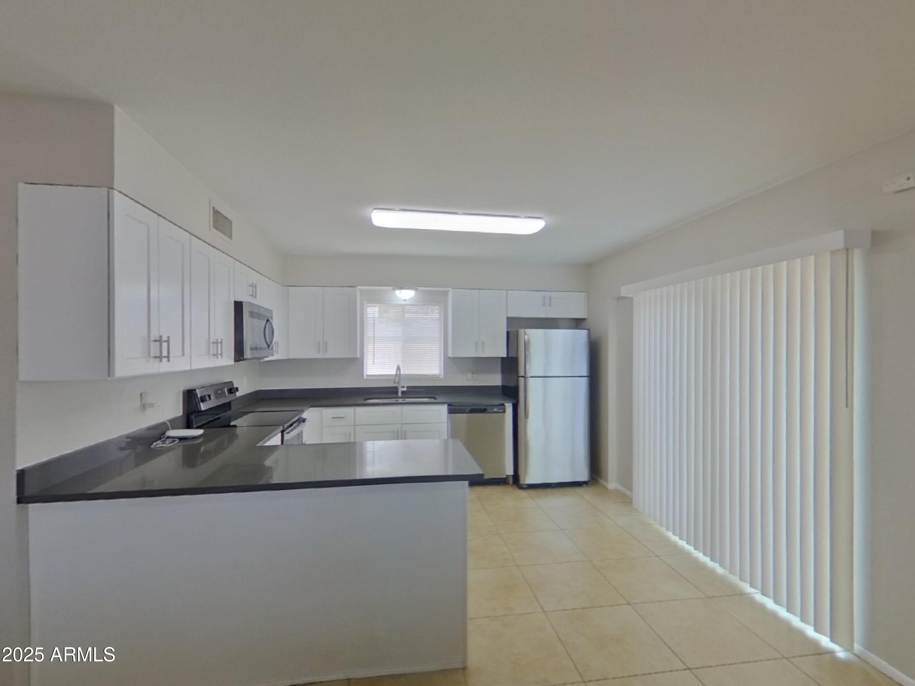 7955 West Montecito Avenue Phoenix, AZ 85033 - Photo 6 of 19 a kitchen with a refrigerator and a sink
