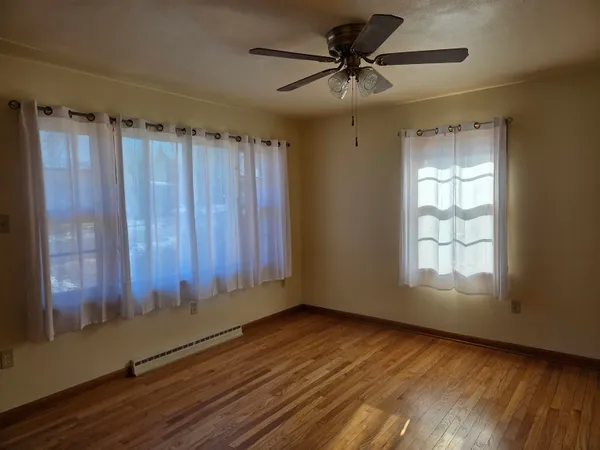 wooden floor in an empty room with a window