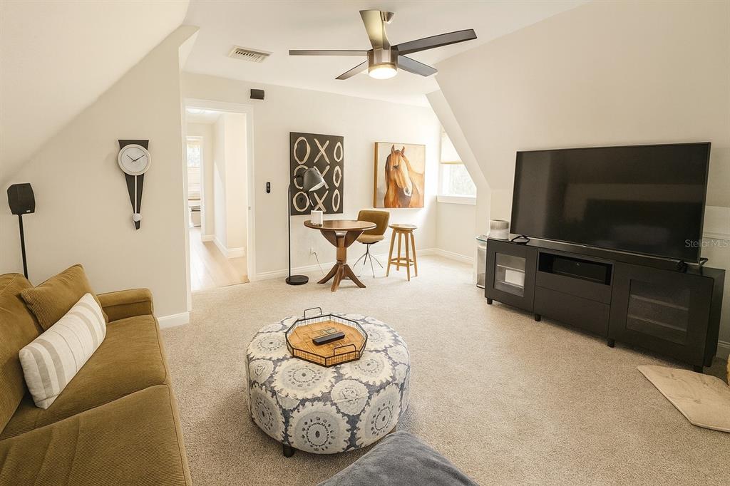 21135 Peckham Avenue Mount Dora, FL 32757 - Photo 17 of 39 a living room with furniture and a flat screen tv