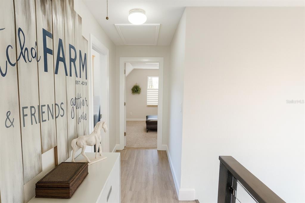 21135 Peckham Avenue Mount Dora, FL 32757 - Photo 19 of 39 a view of a hallway with wooden floor and staircase