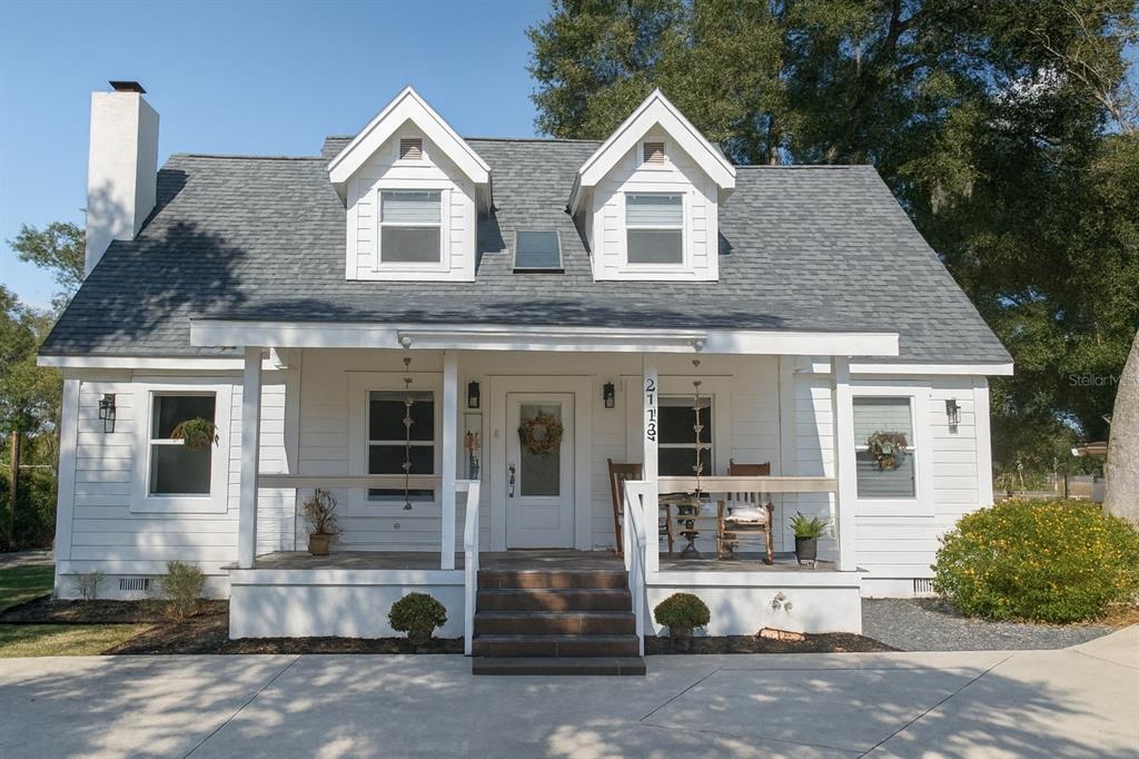 21135 Peckham Avenue Mount Dora, FL 32757 - Photo 2 of 39 a front view of a house with a yard