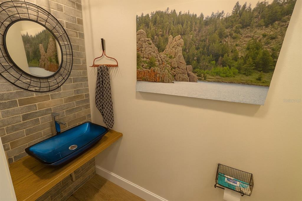 21135 Peckham Avenue Mount Dora, FL 32757 - Photo 22 of 39 a bathroom with a sink and a mirror