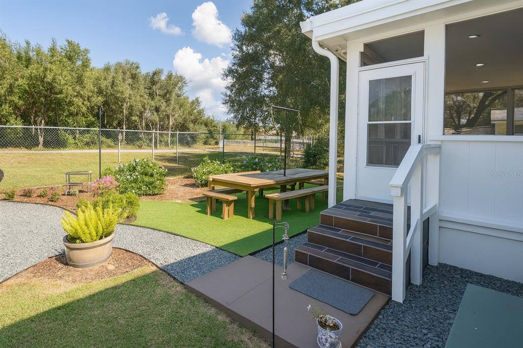21135 Peckham Avenue Mount Dora, FL 32757 - Photo 28 of 39 a view of a chairs and table in the garden