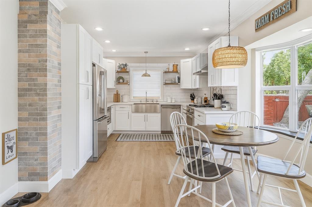 21135 Peckham Avenue Mount Dora, FL 32757 - Photo 8 of 39 a kitchen with stainless steel appliances a dining table chairs and couches