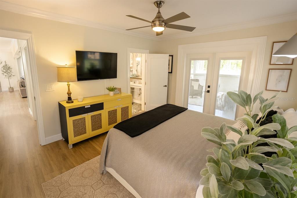 21135 Peckham Avenue Mount Dora, FL 32757 - Photo 10 of 39 a bedroom with a bed flat screen tv and a couch