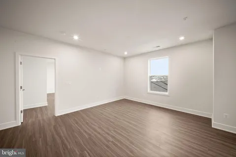 a kitchen with stainless steel appliances kitchen island granite countertop a dining table chairs and granite counter tops