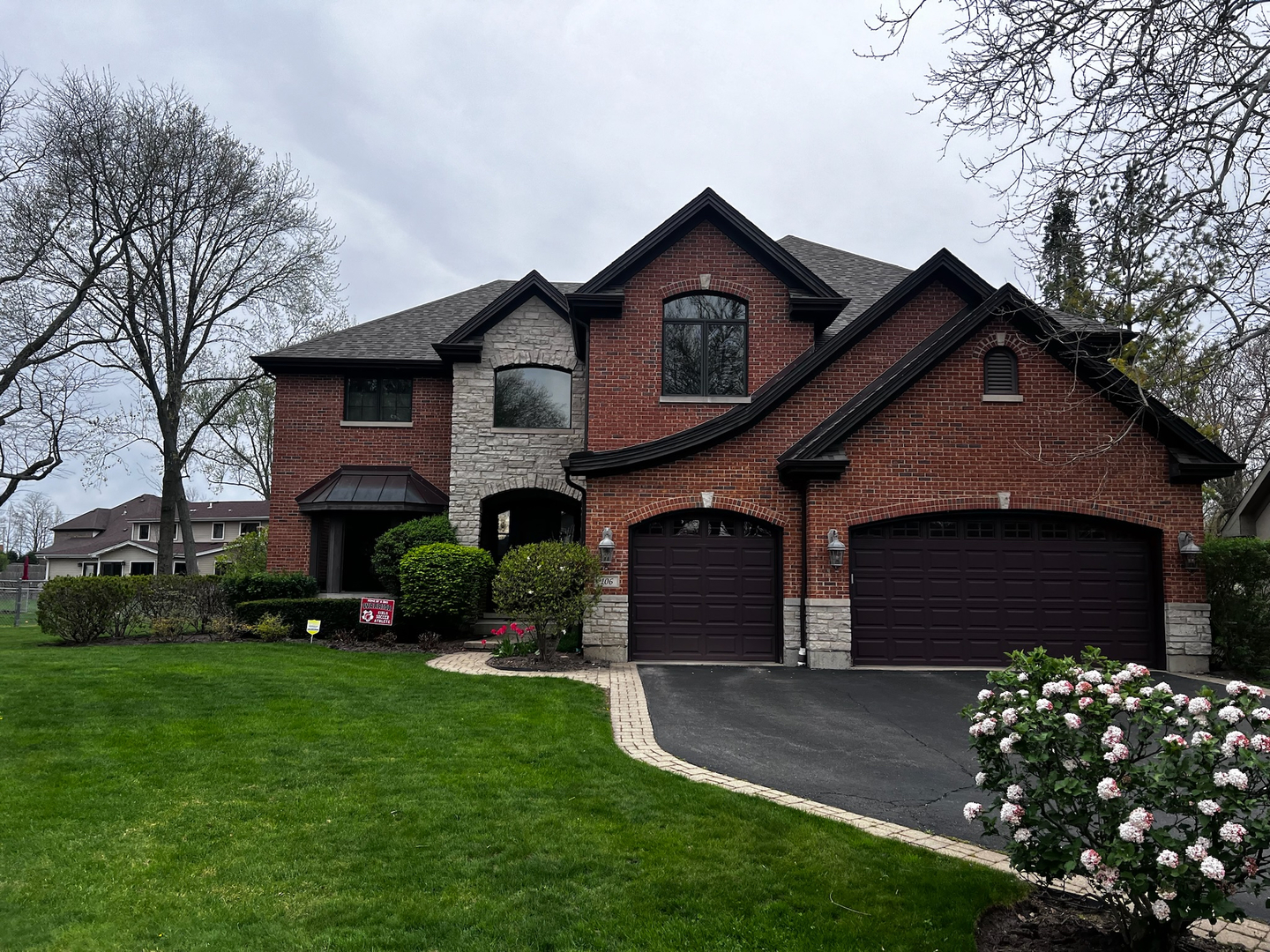 a front view of a house with a garden and plants