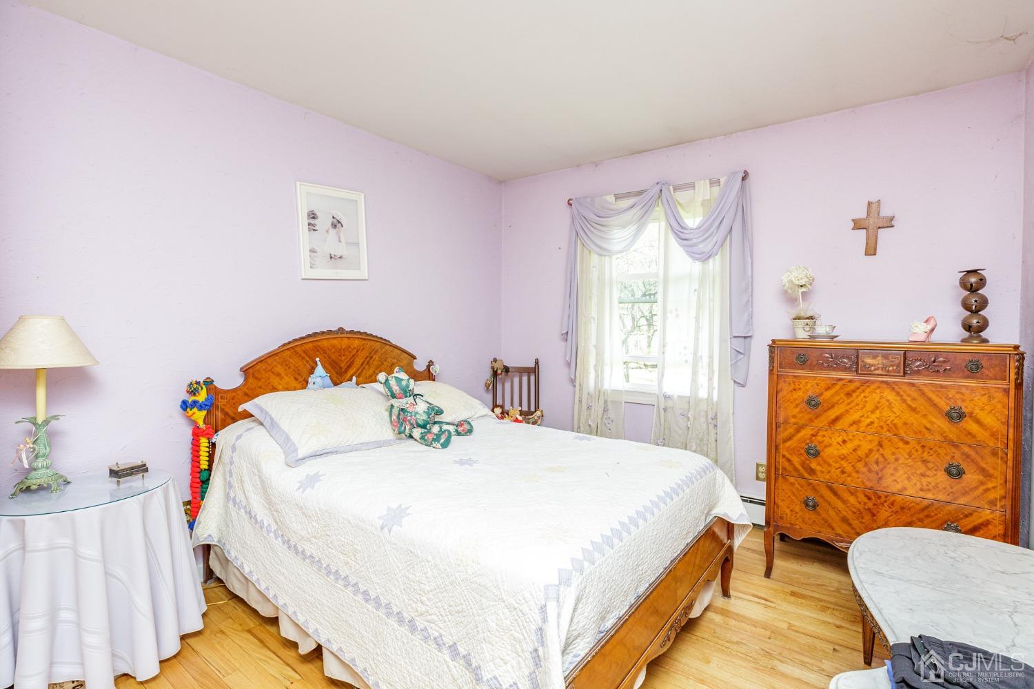 203 Butternut Road Califon, NJ 07830 - Photo 12 of 33 a bedroom with a bed and dresser with wooden floor
