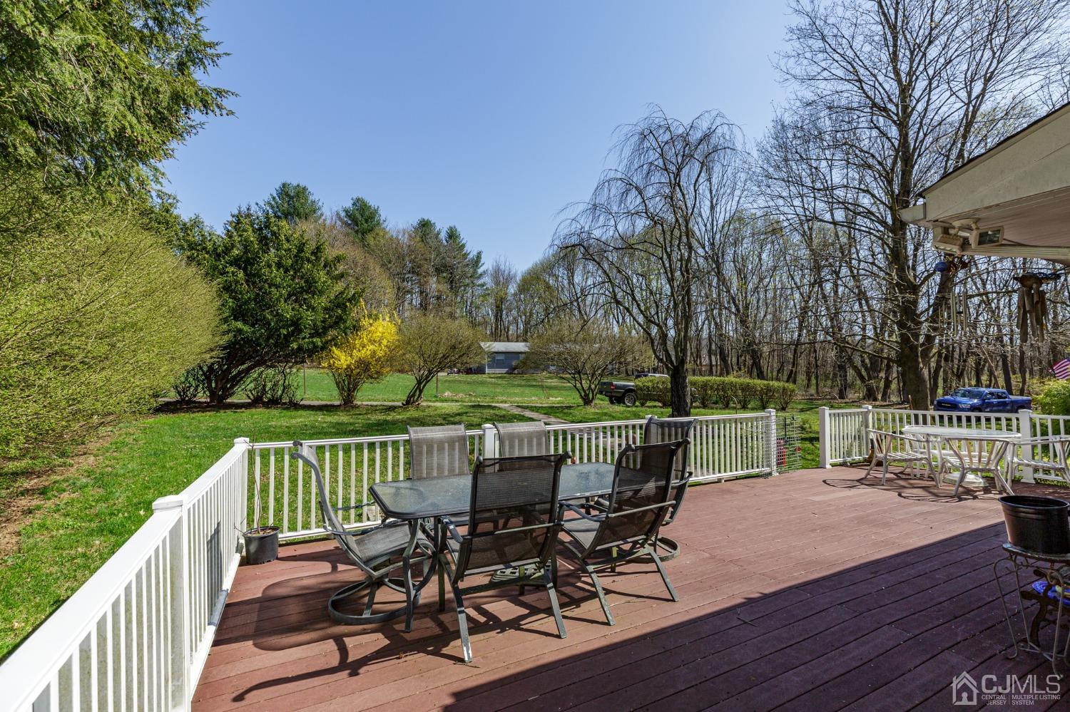 203 Butternut Road Califon, NJ 07830 - Photo 27 of 33 a view of a lake with a deck and a garden