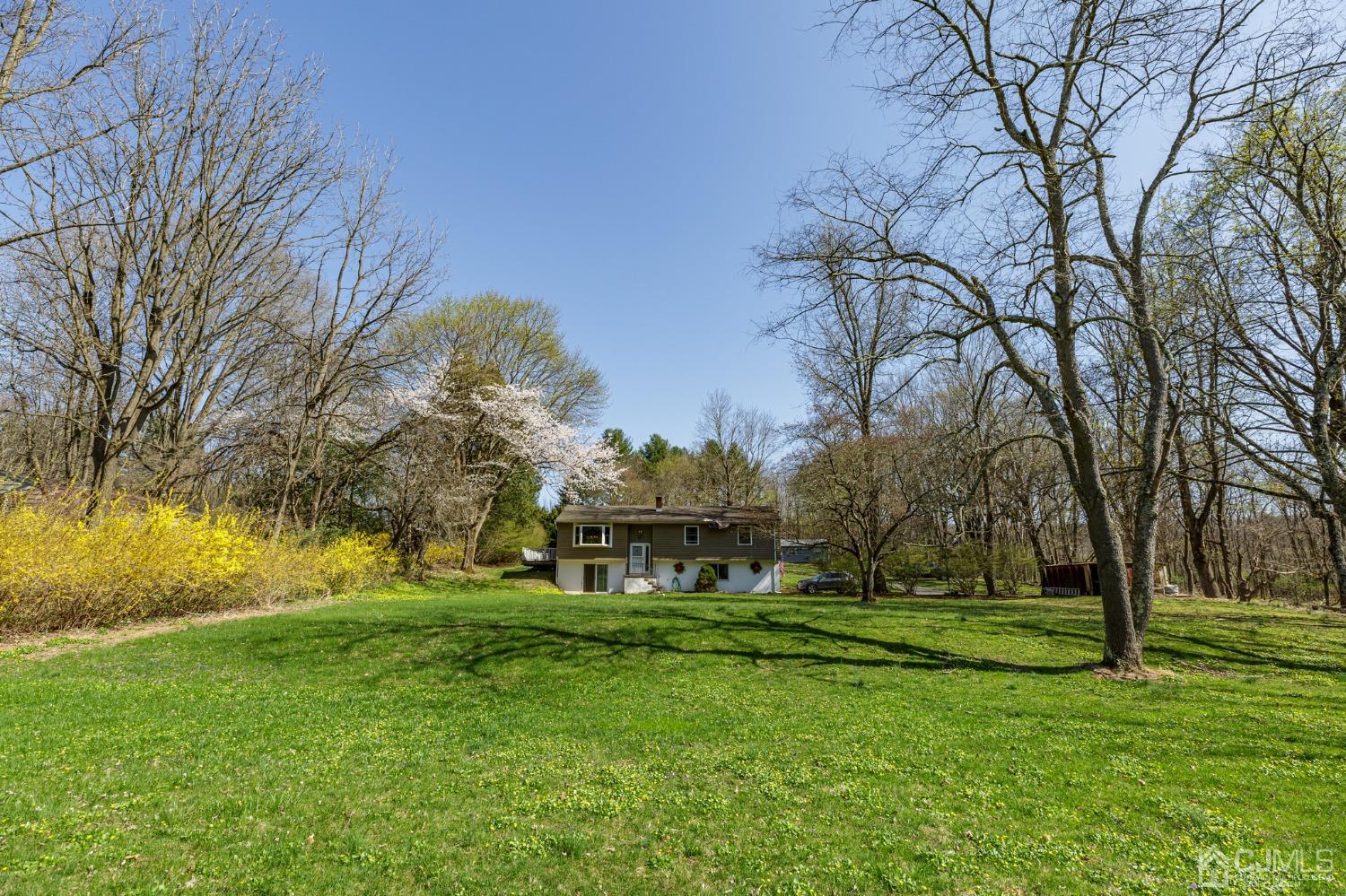 203 Butternut Road Califon, NJ 07830 - Photo 28 of 33 a view of a white house with a big yard and large trees