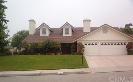 a view of a house with a yard and potted plants