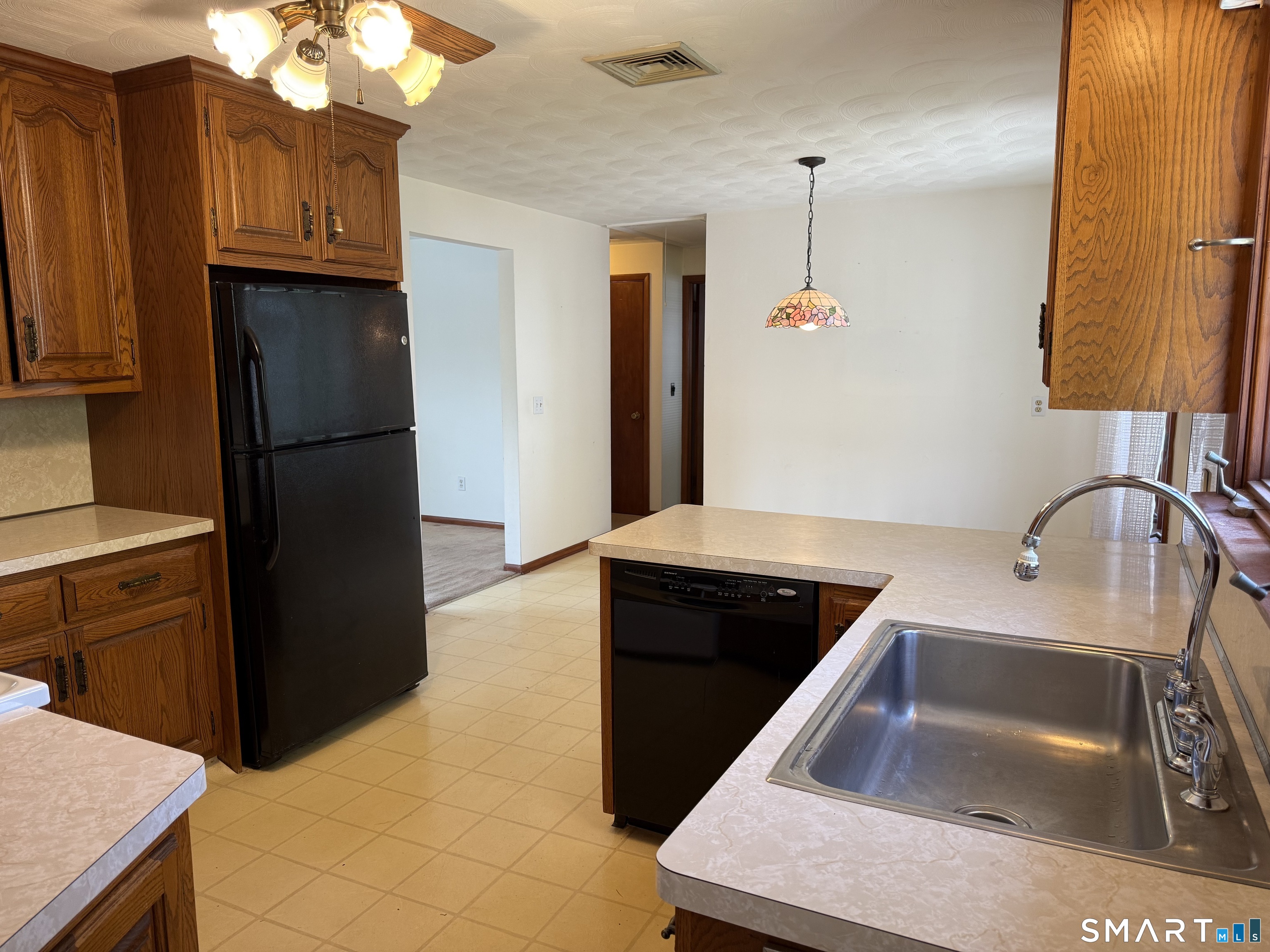 26 Maple Street Trumbull, CT 06611 - Photo 14 of 37 a kitchen with a refrigerator and a sink