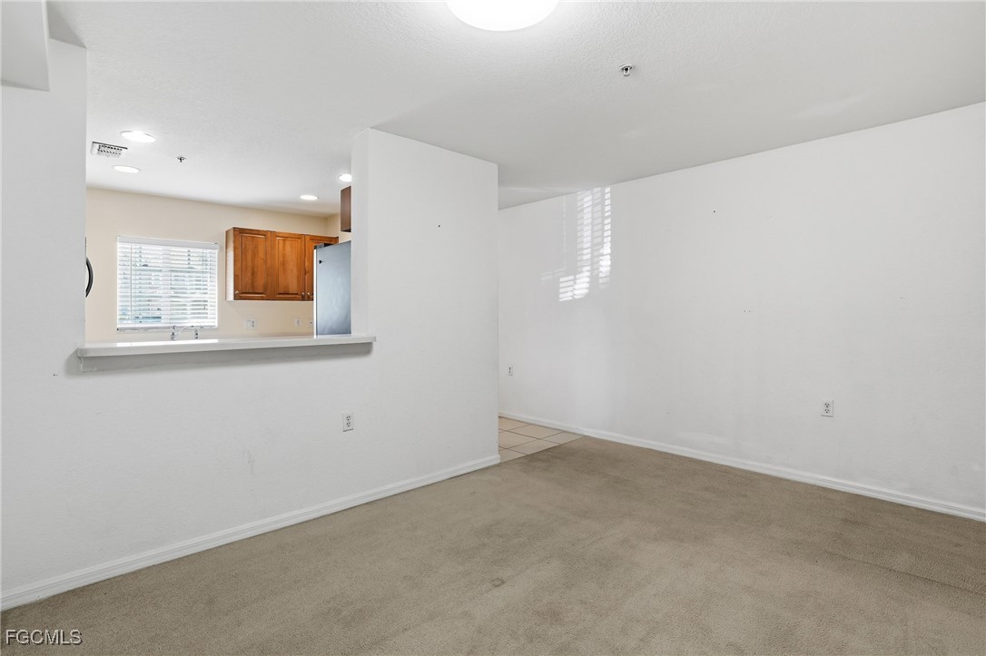 9409 Ivy Brook Run, Unit 1306 Fort Myers, FL 33913 - Photo 13 of 43 an empty room with windows and cabinet