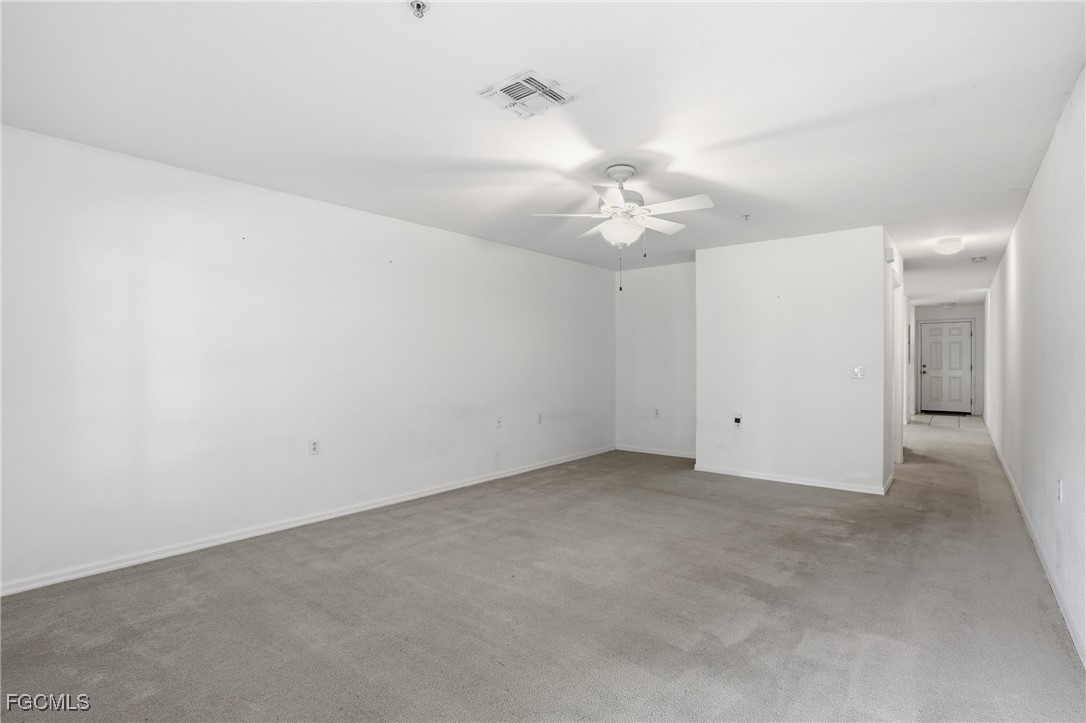 9409 Ivy Brook Run, Unit 1306 Fort Myers, FL 33913 - Photo 15 of 43 an empty room with a ceiling fan and a fan