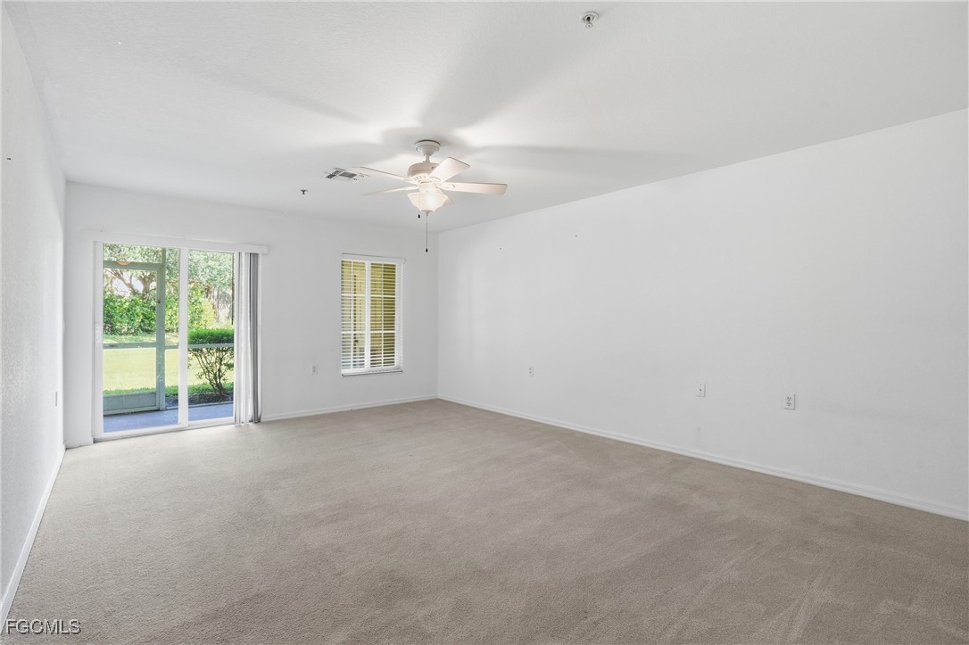 9409 Ivy Brook Run, Unit 1306 Fort Myers, FL 33913 - Photo 18 of 43 an empty room with windows and ceiling fan