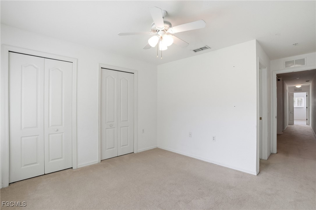 9409 Ivy Brook Run, Unit 1306 Fort Myers, FL 33913 - Photo 19 of 43 an empty room with closet and a ceiling fan