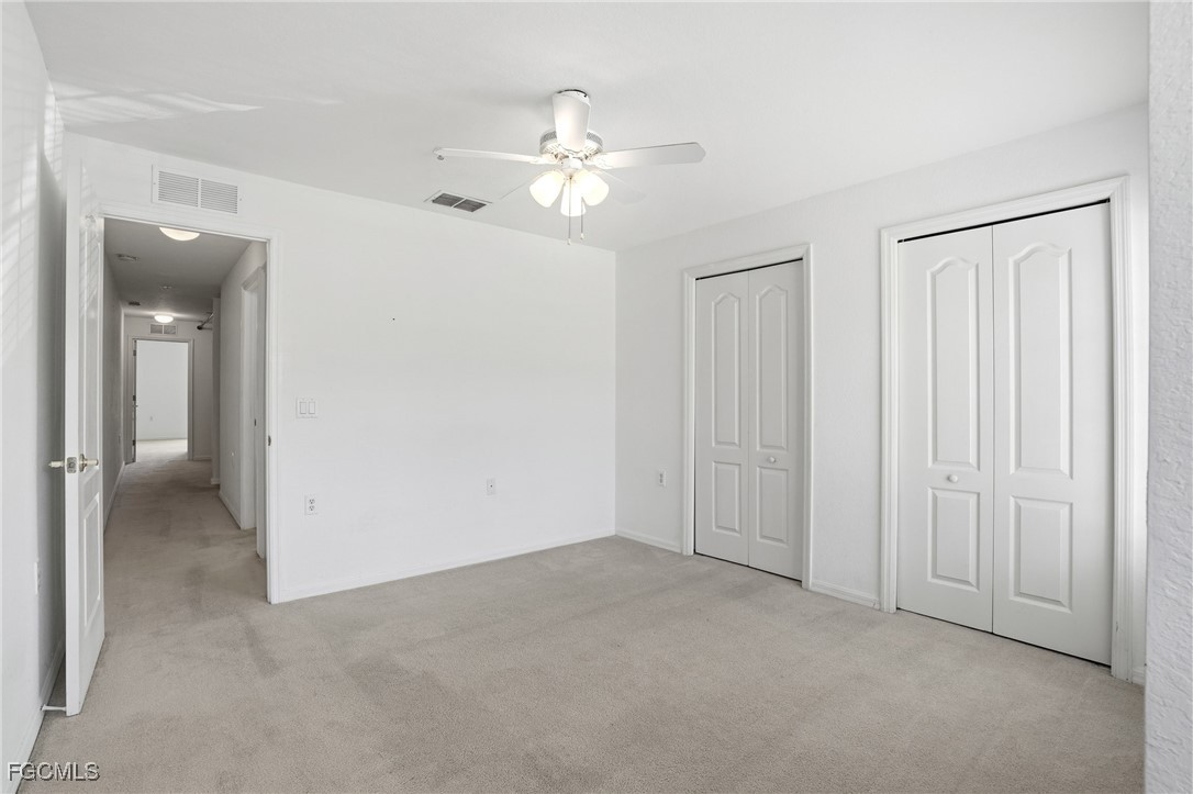 9409 Ivy Brook Run, Unit 1306 Fort Myers, FL 33913 - Photo 26 of 43 an empty room with chandelier fan
