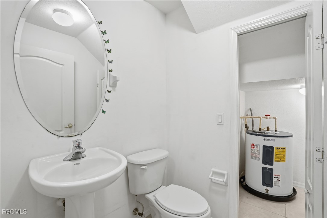 9409 Ivy Brook Run, Unit 1306 Fort Myers, FL 33913 - Photo 31 of 43 a bathroom with a toilet sink and mirror