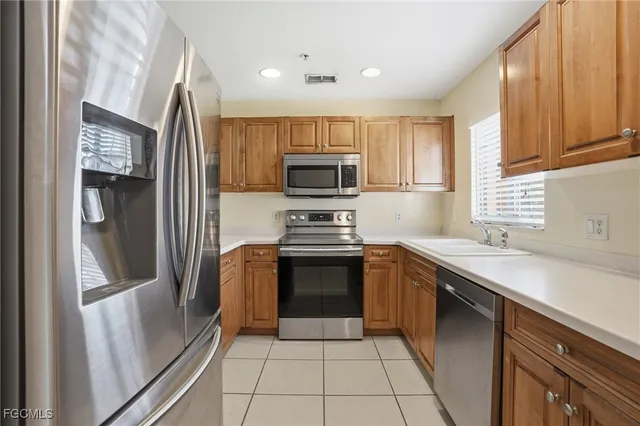 a kitchen with a sink stove and microwave