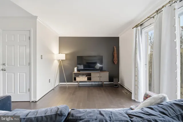 a living room with a bed furniture and a window