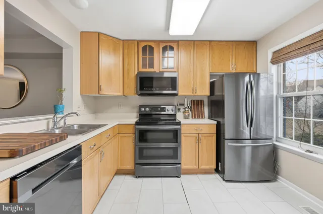 a kitchen with a refrigerator and a sink
