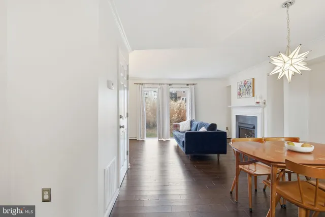 a living room with fireplace furniture and a wooden floor
