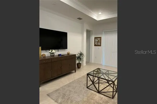 a living room with furniture and flat screen tv