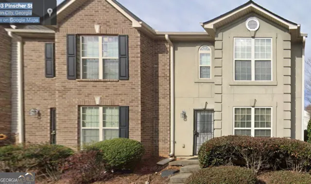 a view of a brick house with large windows