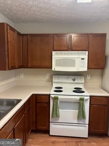 a stove top oven sitting inside of a kitchen