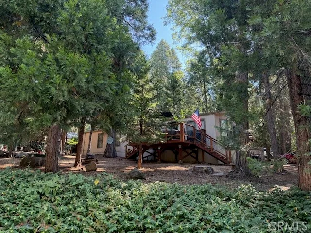 a view of a house with trees in the background