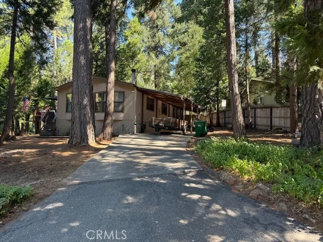 a front view of a house with a tree