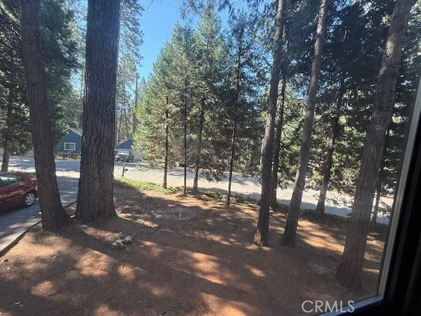 a bedroom with a bed and a mirror on dresser