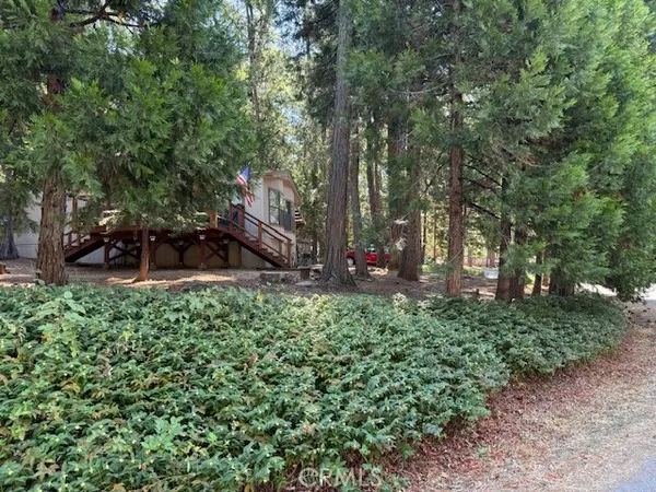 a view of a house with trees in the background